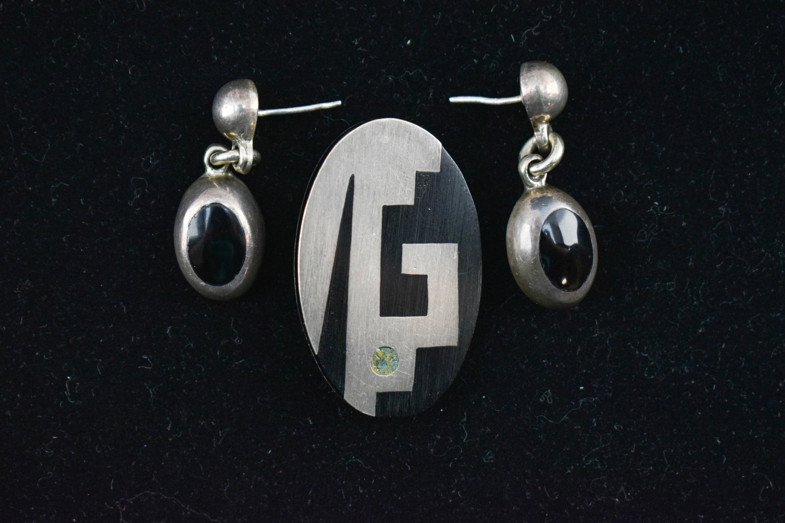 Mexican Sterling Silver and Onyx Brooch and Earrings: Includes an RHI brooch made in Mexico with onyx inlays and a pair of Taxco TJ-37 earrings with oblong onyx inlays. All are made of sterling silver and feature 925 markings. Dimensions describe the bro