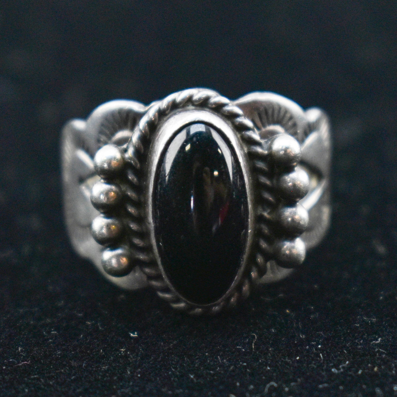 Etched Sterling Silver Onyx Ring: Vintage sterling silver ring featuring an onyx stone inlay, triangular cutouts, and etched wave forms.