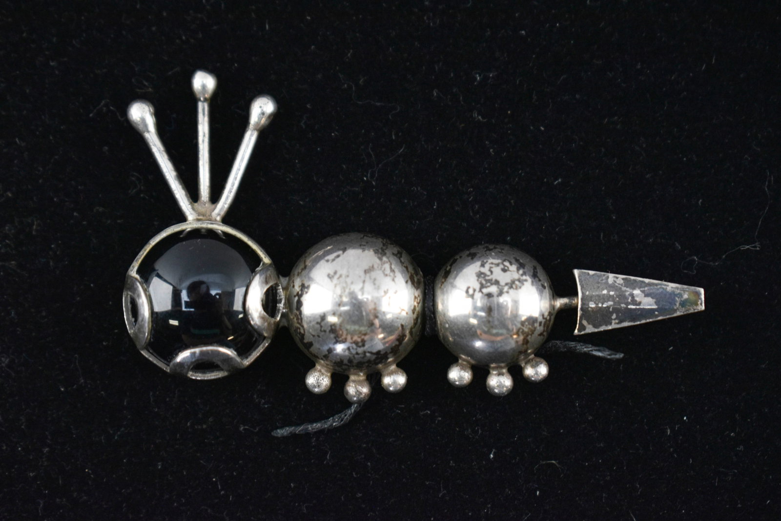 Taxco Sterling Silver and Onyx Caterpillar Brooch: Whimsical caterpillar-shaped brooch made from sterling silver in the Mexican town of Taxco. Taxco de Alarcon was a hub for silver artisans throughout the 20th century, and this piece features Taxco an