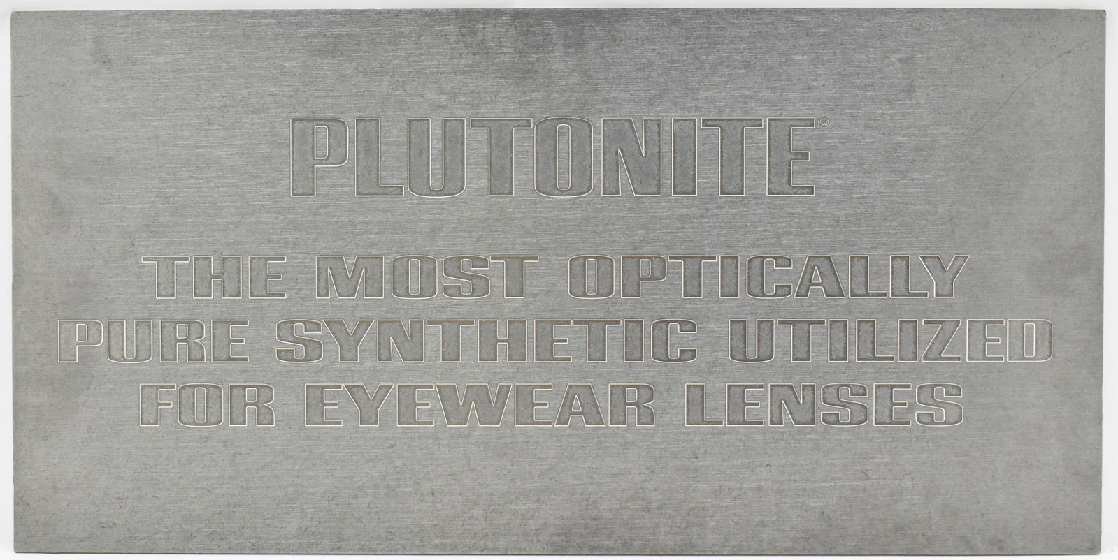 Oakley Plutonite Rectangular Steel Display Sign: Reads: Plutonite, The Most Optically Pure Synthetic Used for Eyewear Lenses.