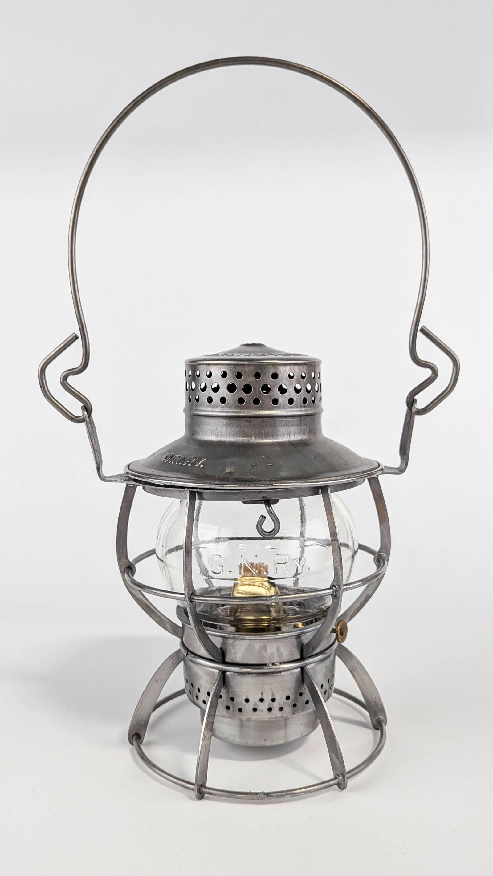 Dressel Great Northern Railroad Clear Lantern: One Dressel clear glass lantern for the Great Northern Railroad. Raised lettering "Dressel Arlington, N.J." along the lid. Raised G.N.RY. along the lid. Raised lettering along the glass glob