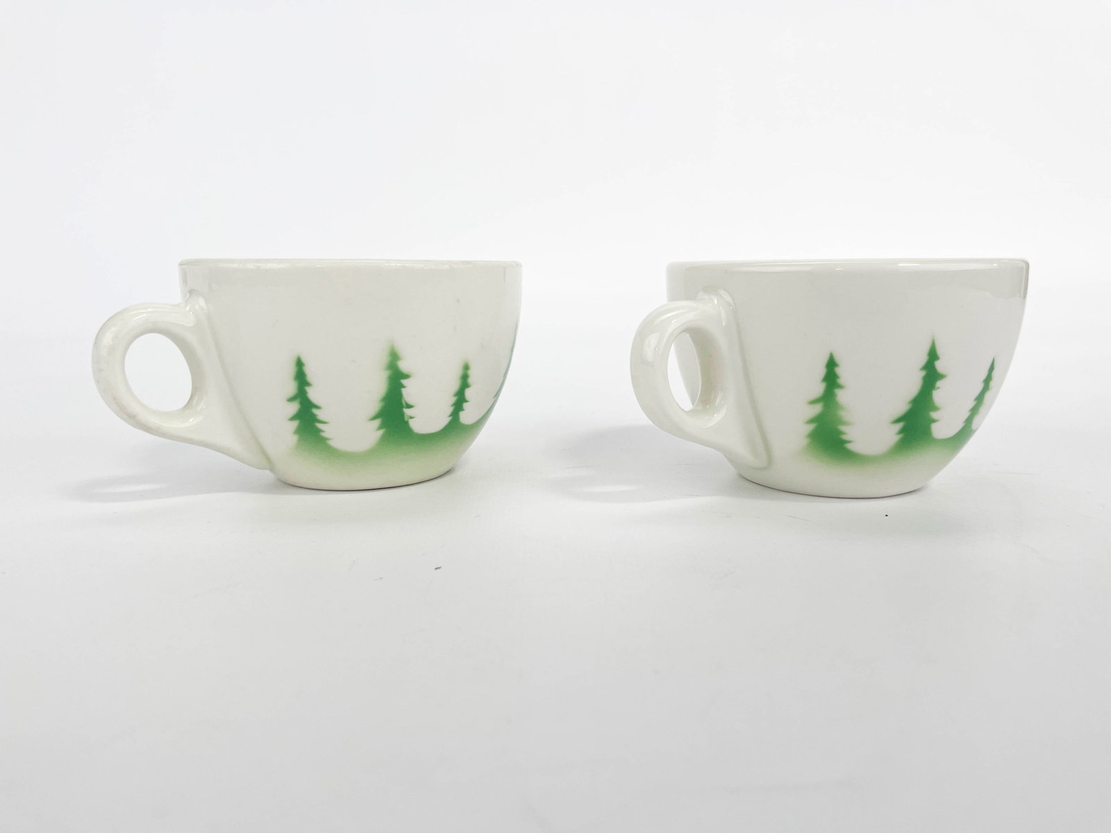2 Great Northern Railway Glory of the West Coffee Cups: Two Great Northern Railroad "Glory of the West" China coffee cups. One cup marked "AA-6 Syracuse China G.N.Ry" along the underside; the other cup marked "Great Northern Railro