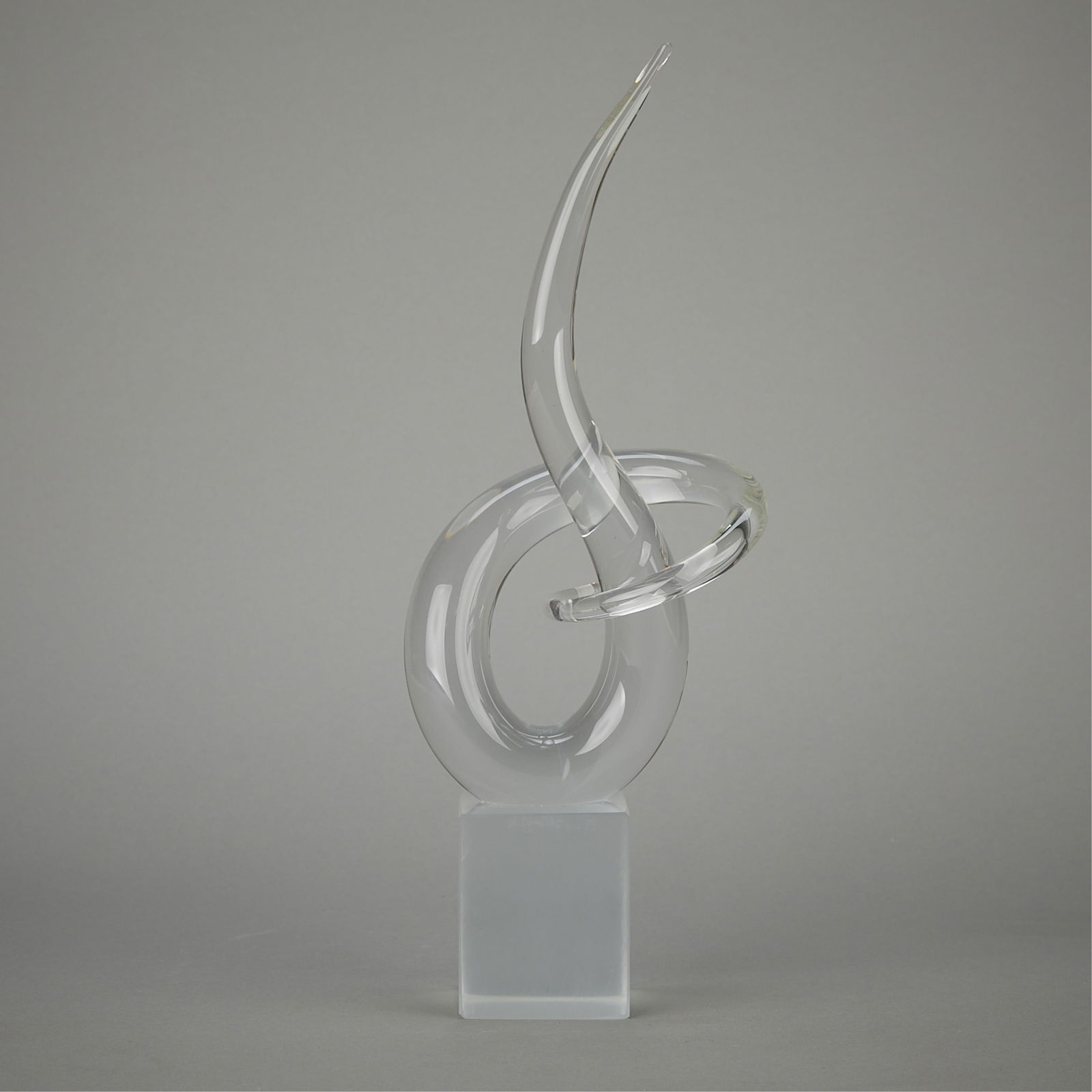Renato Anatra Clear Glass Figural Sculpture: 13" x 5.5" x 3". Swirling abstract sculpture attached to rectangular base. Upper portion is clear glass while the base has a slightly frosted look. Signed R. Anatra on the base.13 x 5.5