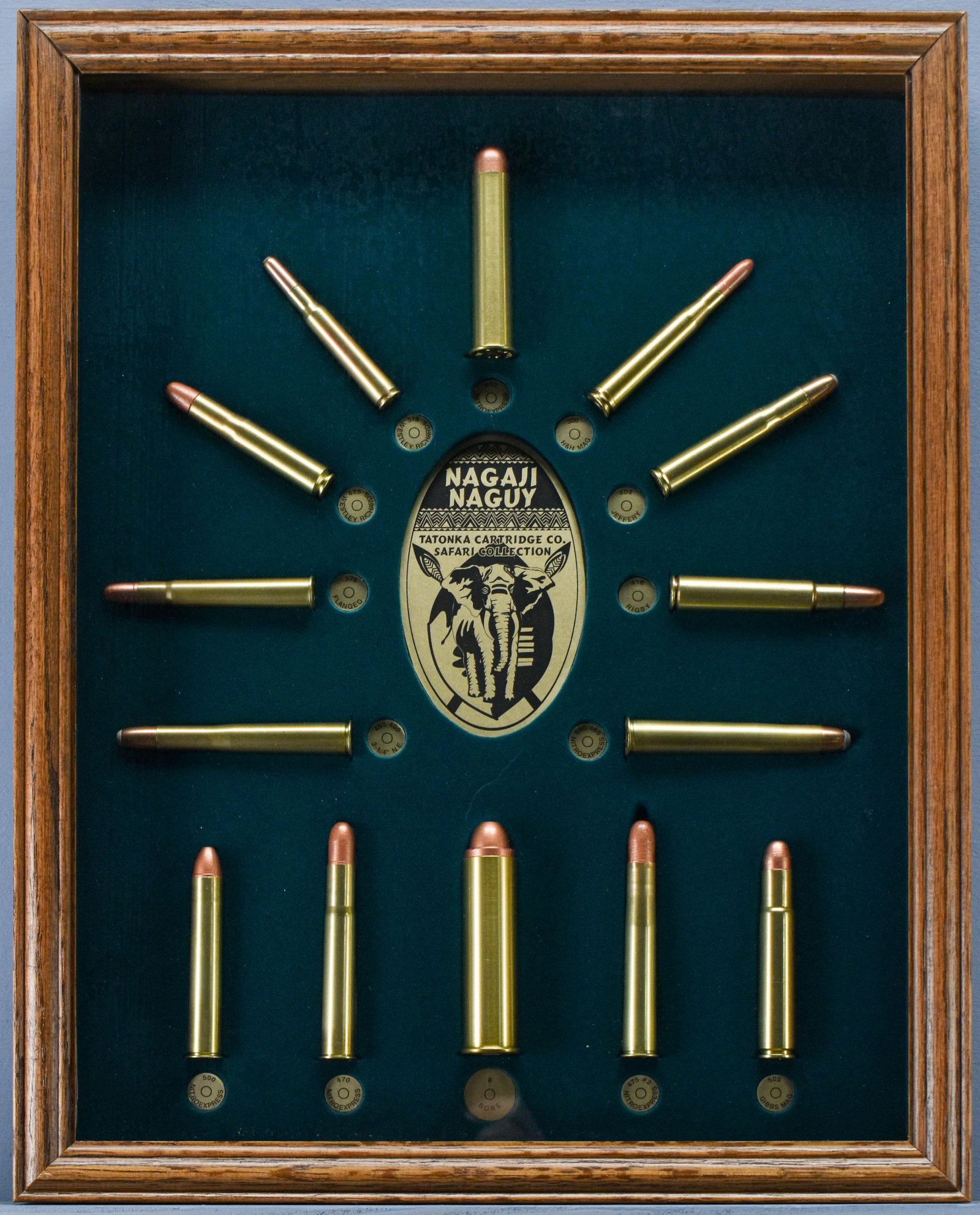 Nagaji Naguy Tatonka Cartridge Co. Safari Collection Shadowbox Display: An extremely fine collection of old, renowned Tatonka safari cartridges displayed in a green velvet-lined walnut case behind glass. Ranging from as small as the 30 Super (a.k.a. 300 H&H) to the giant 