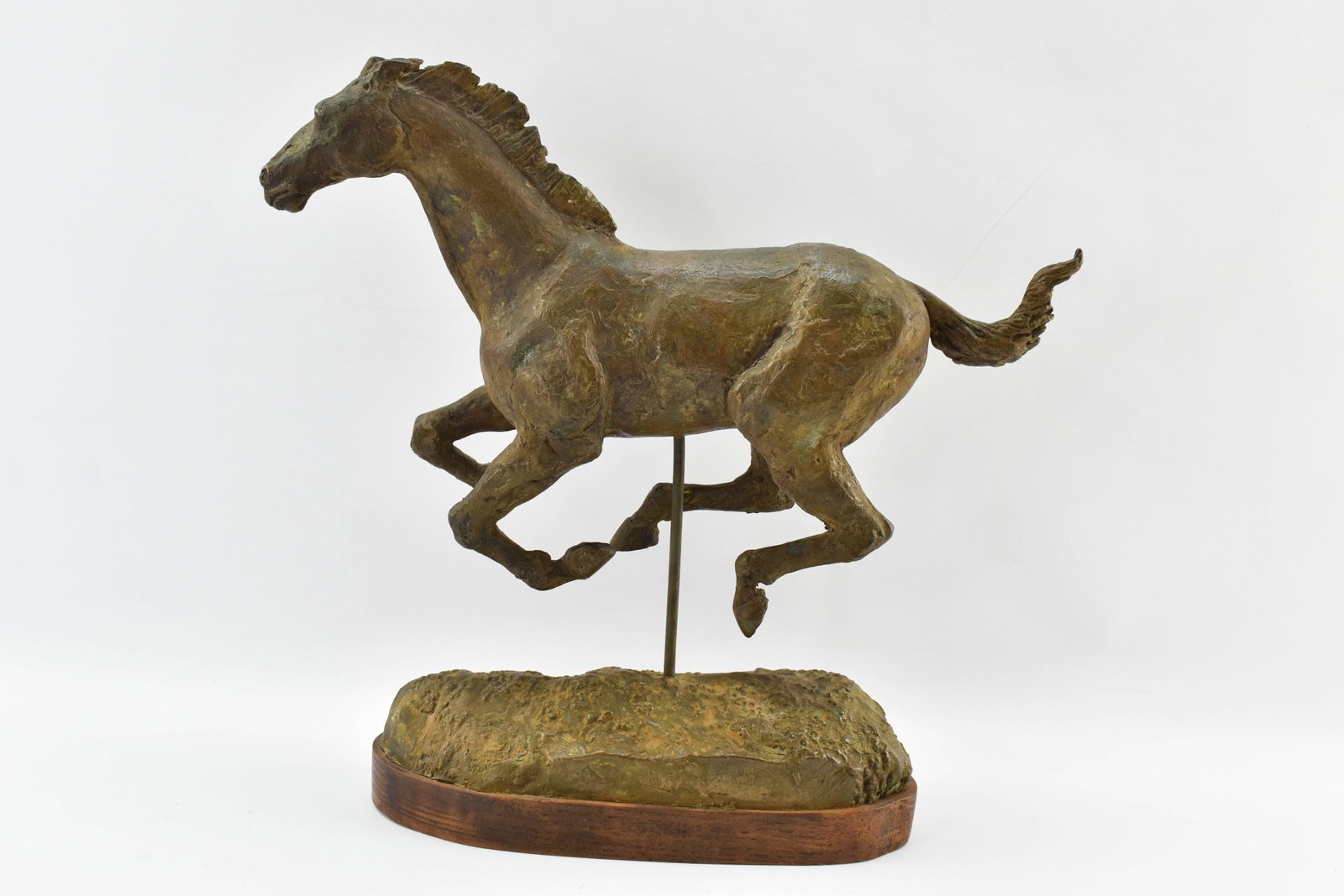 Bronze Horse Sculpture: Sculpture of galloping horse made from bronze and mounted on wood base. No visible signature on the bronze. "HY GLICKMAN" is written on the underside of the wood base in pen. 10"H x 11&