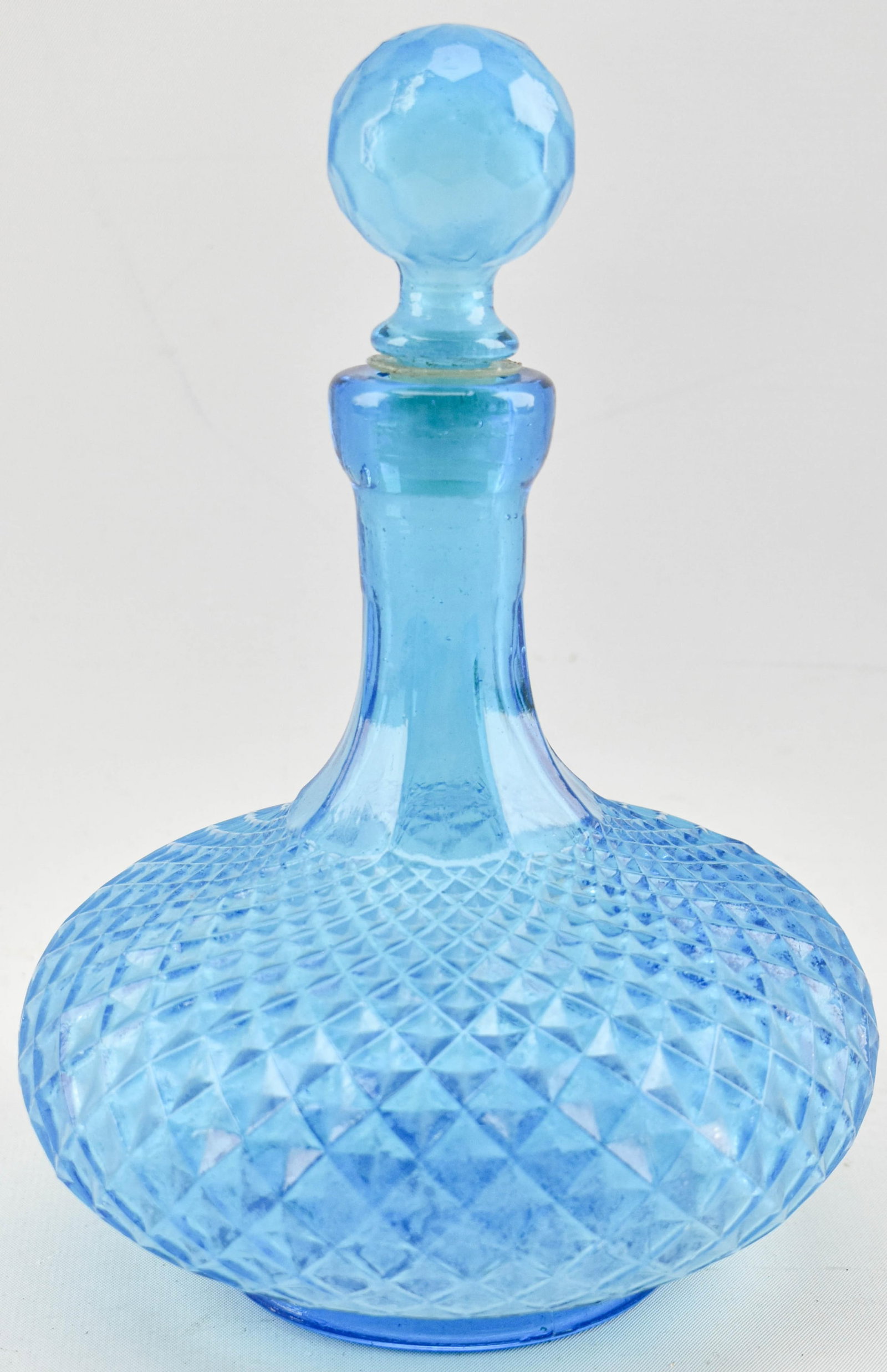 Empoli Blue Diamond Point Style Glass Decanter: Blue glass decanter in the style of Empoli Blue Diamond Point decanter. Diamond criss-cross pattern all over the basin and stopper as well as fluted details on neck. Marked on underside "Made in 