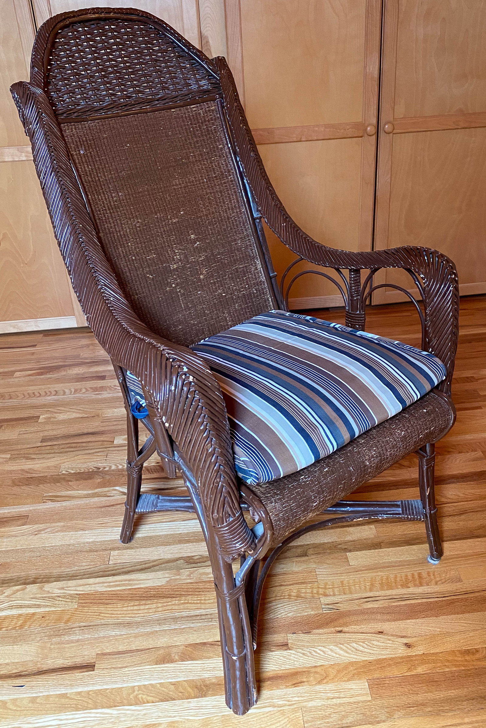 Vintage Brown Painted Rattan Chair: Brown painted rattan armchair with upholstered seat cushion. 46'H x 26"W x 24"D.