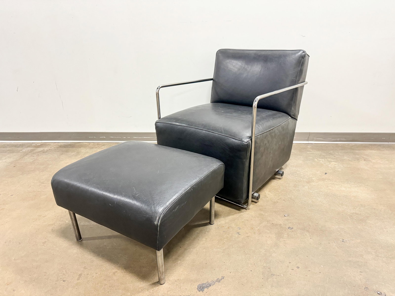 McCreary Modern Art Deco Style Leather Chair & Ottoman: McCreary Modern brand art deco style chair with chrome frame and leather or PU leather cushions.32 x 27 x 32