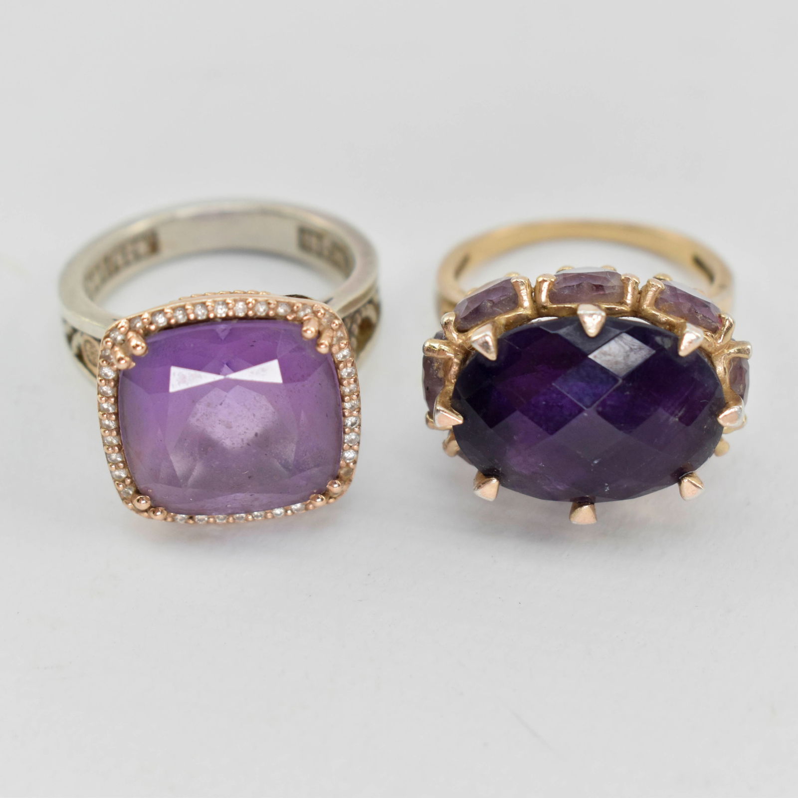 2 Rings with Purple Stones, Sz 6 & 6.5: Lot includes a Sterling and 18K gold ring with a large central purple stone and small diamonds around it (sz. 6.5) and a ring with a large dark purple stone and smaller light purple stone (sz. 6). Thi