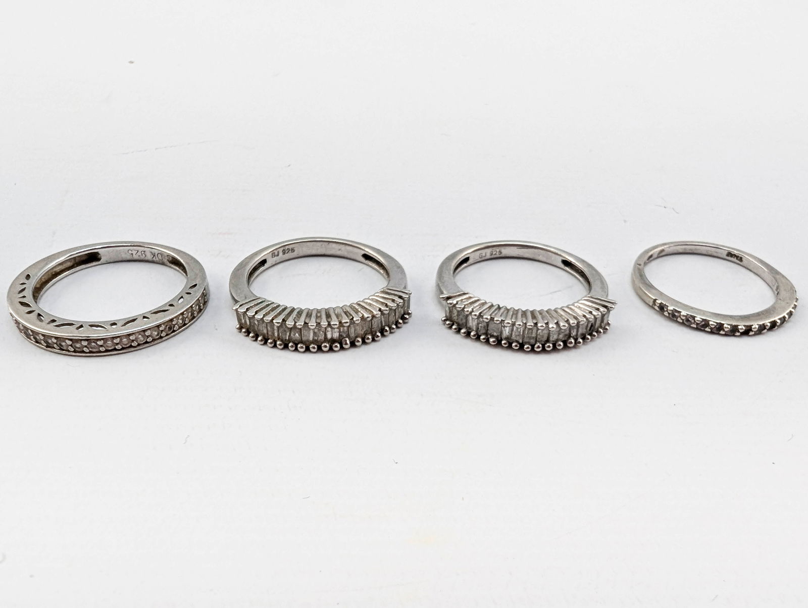 4 Stackable Sterling Silver Rings, Sz 5: Group of 4 stackable rings, all marked 925 and size 5. All set with small colorless stones.