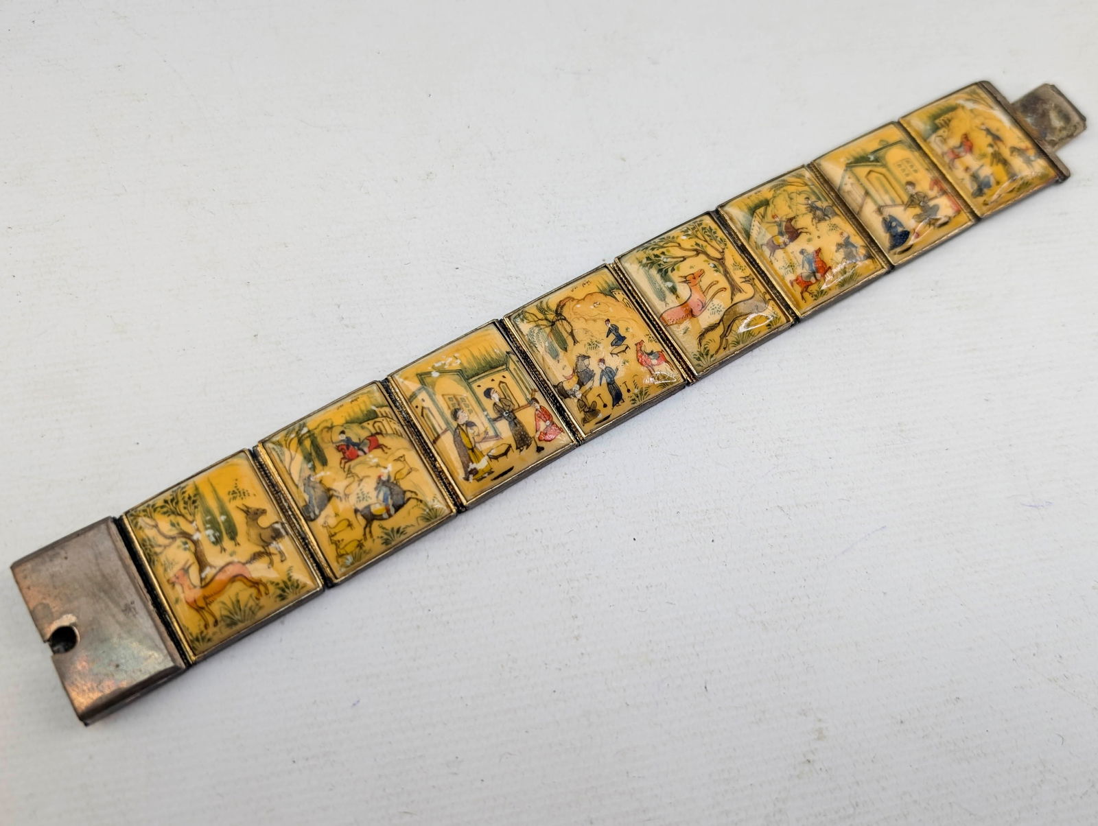 Persian Bone Story Book Panel Bracelet: 8-panel bracelet painted with inidvidual scenes. Appears to be painted on bone. Item does not stay clasped.7.25"L x 1"W