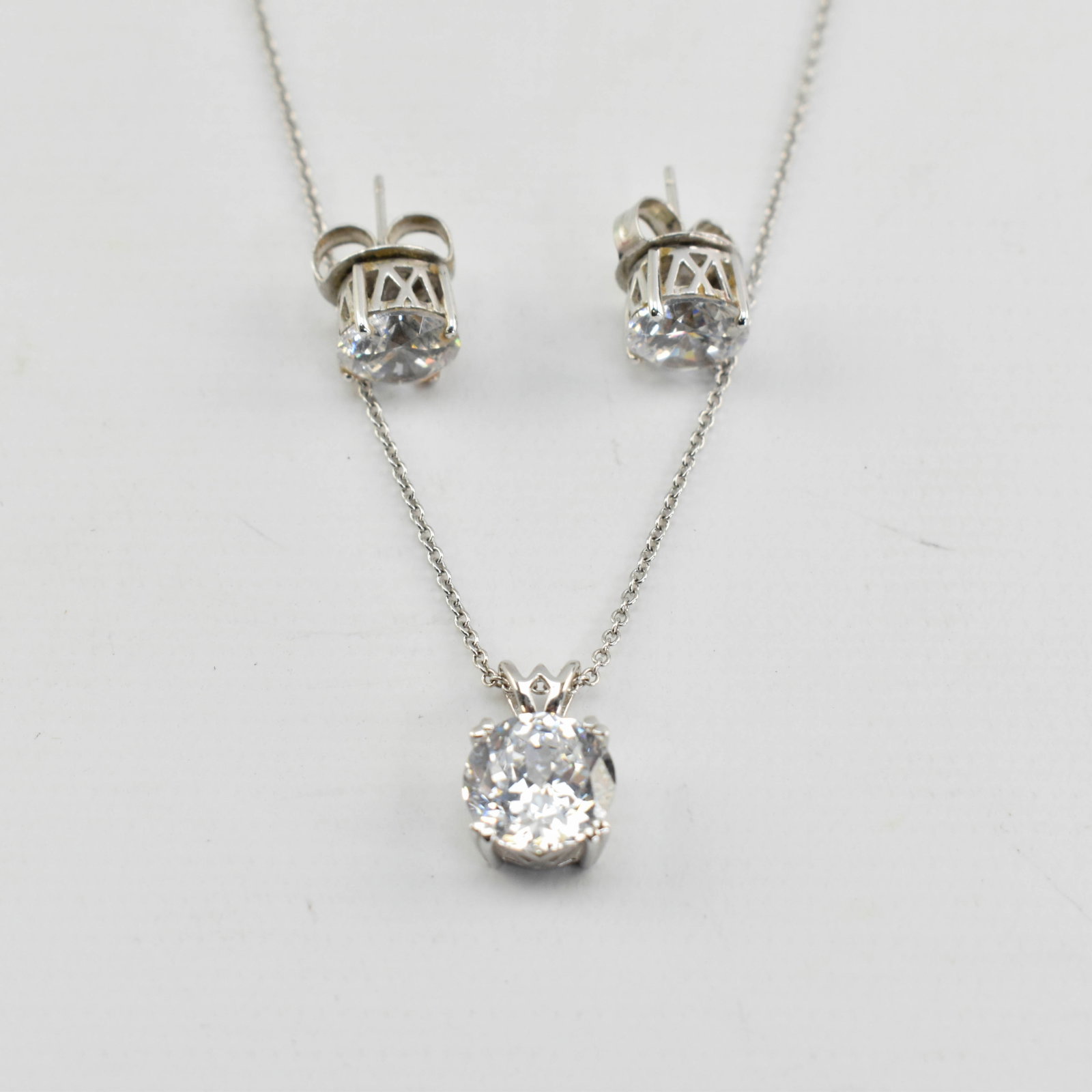 Charles Winston Rhodium Plated Sterling Earrings & Necklace Set: Lot includes a necklace and pair of earrings with cubic zirconia set in rhodium plated sterling silver. Each marked 925.