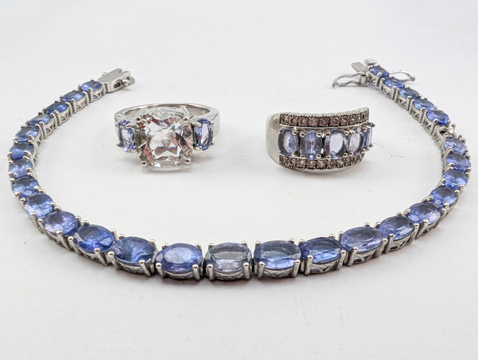Sterling Silver Rings and Bracelet: Lot includes 2 rings (sz. 6) and a 7.5" bracelet set with lavender or blueish lavender stones. Each marked 925