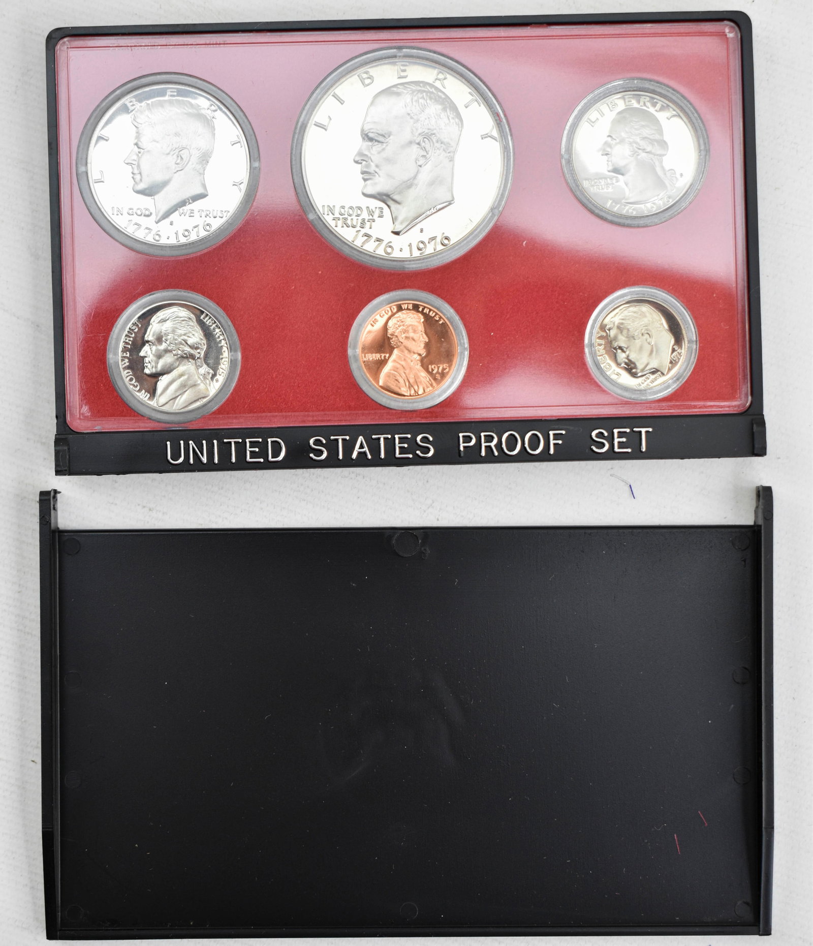 1975 U.S. Proof Set: 5 coin proof set in plastic case and cardstock sleeve. Set pictured is set you will receive. 3.5"H x 5.5"W x 0.5"D.