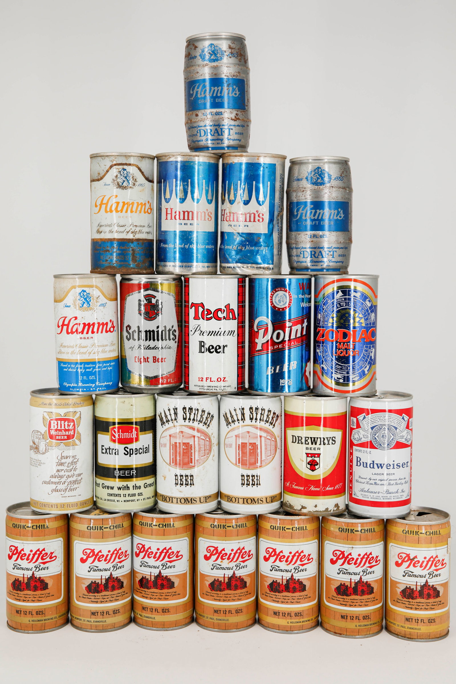 Assortment of 23 Vintage Beer Cans from Brands Including Hamm's, Pfeiffer, Main Street: Lot of 23 - 2 aluminum and 22 steel with a combination of top opened and bottom opened vintage beer cans. This lot features brands including Pfeiffer, Hamm's, Budweiser, Drewry's, Main Street, Schmidt