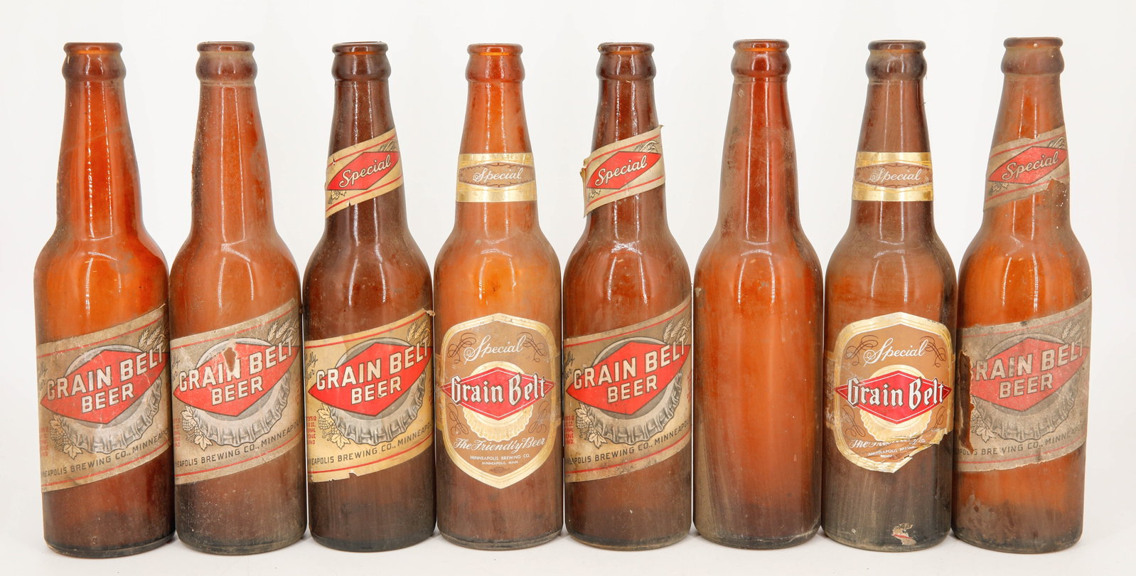 Assortment of 8 Vintage Grain Belt Returnable Beer Bottles: Lot of 8 vintage Grain Belt returnable beer bottles. One bottle has the label missing. 12 Fl Oz.