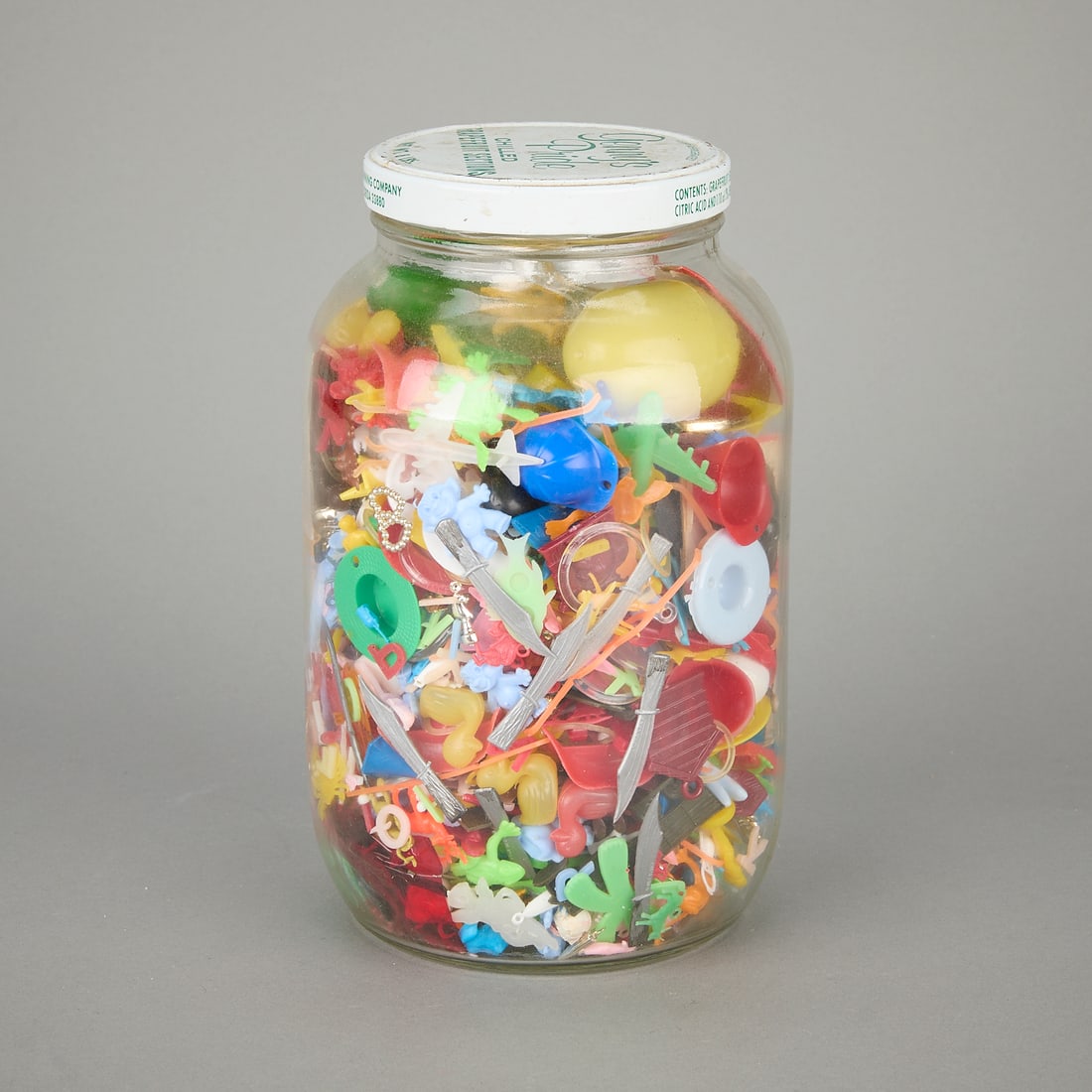 Vintage Plastic Toys and Prizes in Glass Jar: Hundreds of small plastic toys and/or prizes in an old grapefruit jar.Jar: 10H x 6Dia