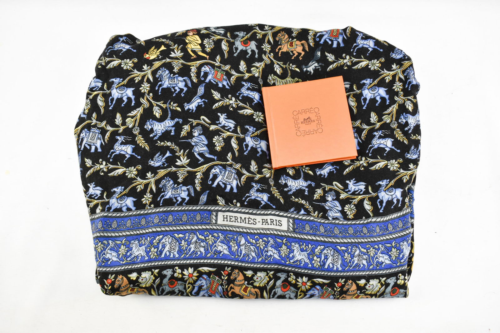 Hermes Chasse En Inde Cashmere Pashmina: Hermes Paris cashmere pashmina 'Chasse En Inde' featuring an Indian inspired design with elephants, tigers, horses, and other animals alongside depictions of soldiers in a primarily blue, yellow, red,