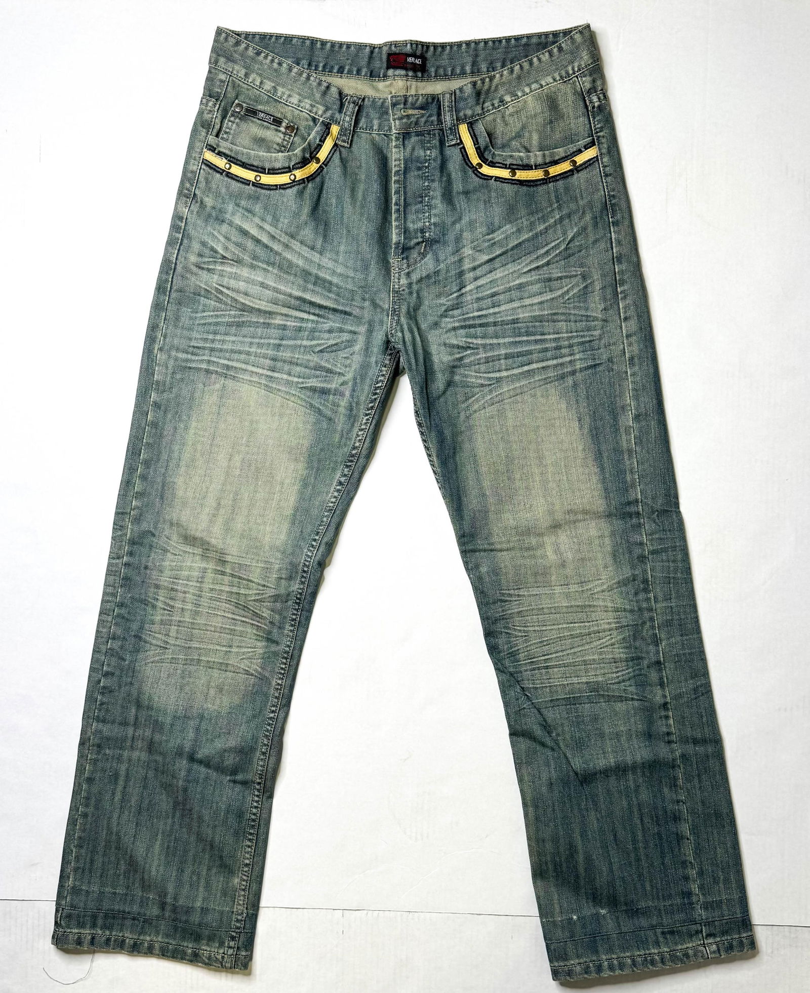 Versace Black & Yellow Embroidery Jeans, 36/34: Versace jeans with black and light blue embroidery and yellow woven bands with rivets along the pockets. Size unmarked, most likely 36W 34L.12 x 12 x 1.5 in