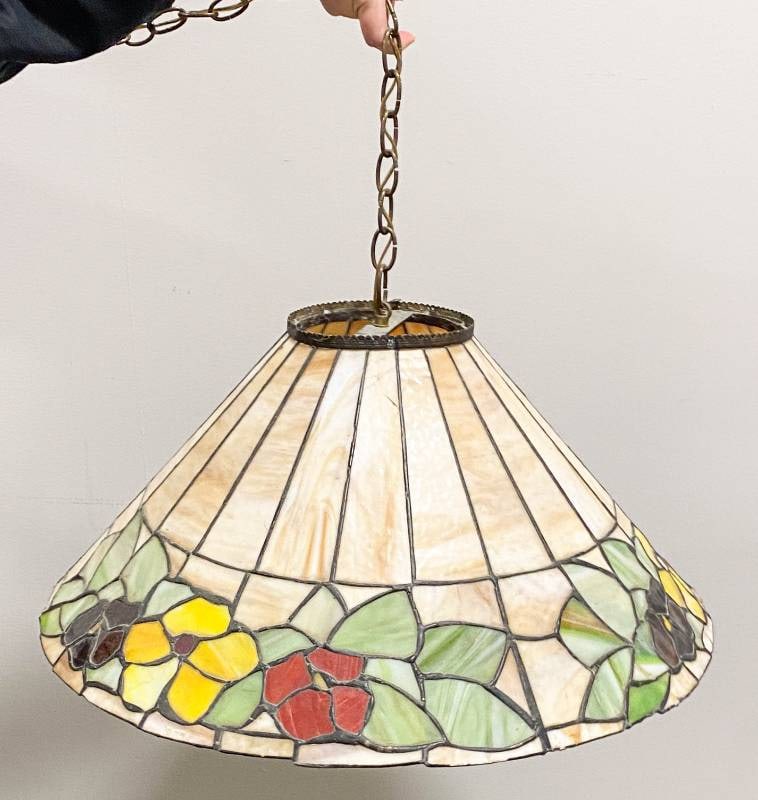 Large Tan Floral Tiffany Style Hanging Shade: Tan Tiffany style lamp with purple, yellow, and red flowers throughout the rim, metal chain link pendant, and singular socket, lightbulb not included. CHAIN 34"L SHADE 25"Dia.