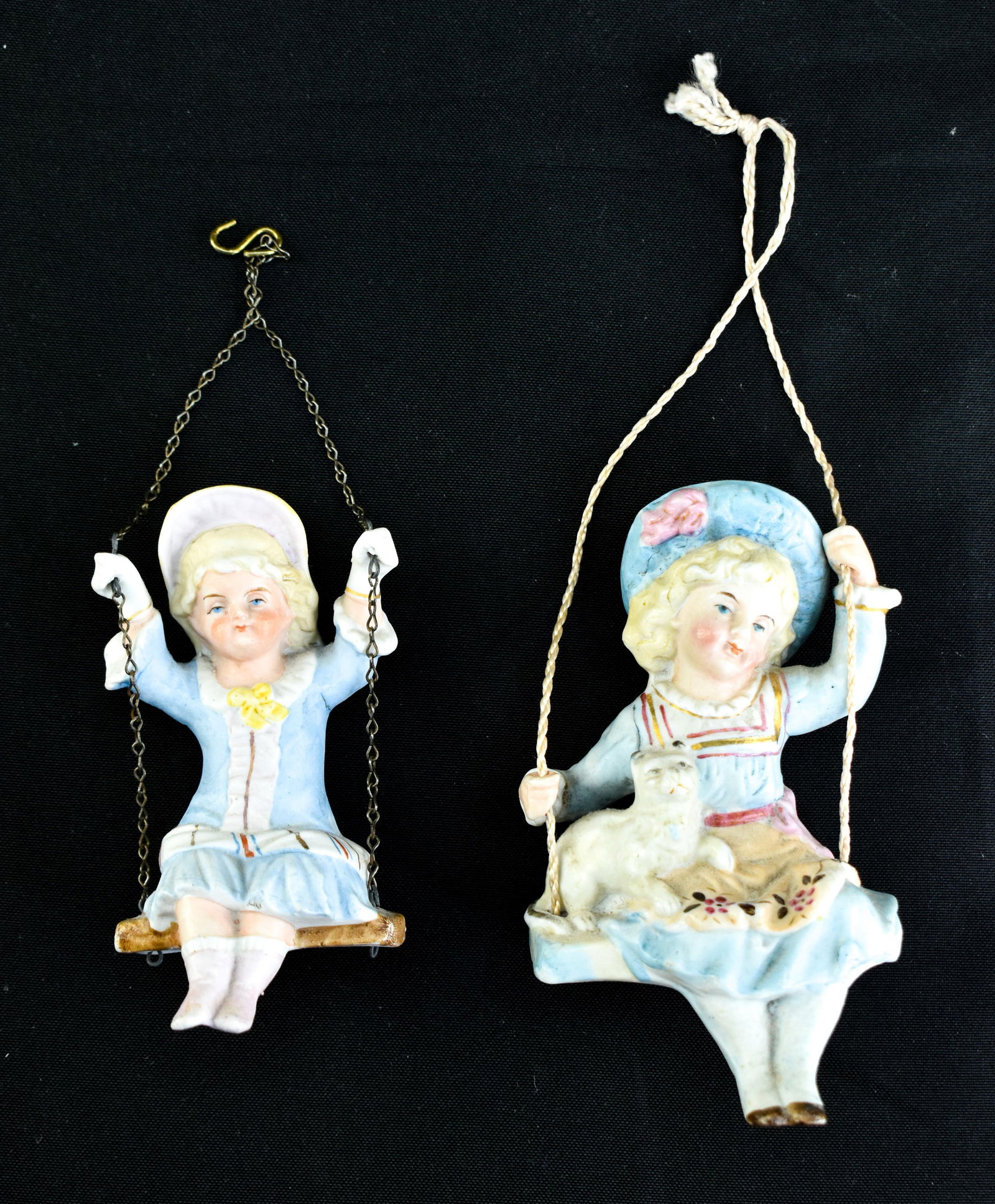 2 Antique Porcelain Lamp Swingers: Lot includes two antique porcelain lamp swingers in the form oof young girls (one with a pet!).Larger figure (porcelain only) 5.5"H x 3"W x 2.5"D.