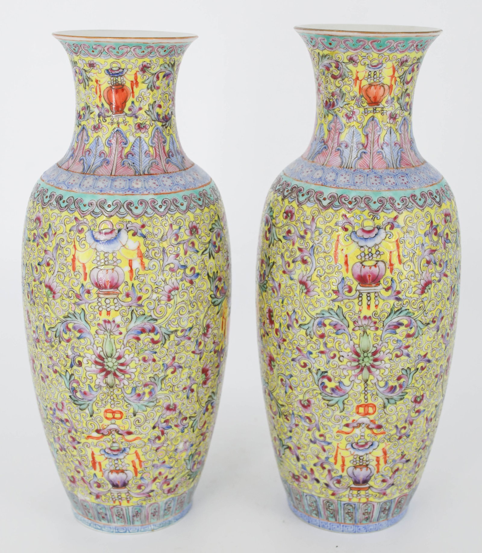 Pair of Qing Dynasty Chinese Famille Rose Porcelain Vases: Pair of Antique Famille Rose Chinese porcelain bases with beautiful intricate floral patterns in vibrant pink, blue, yellow, red, and green. Each is marked with what appears to be Da Qing Qianlong Nia