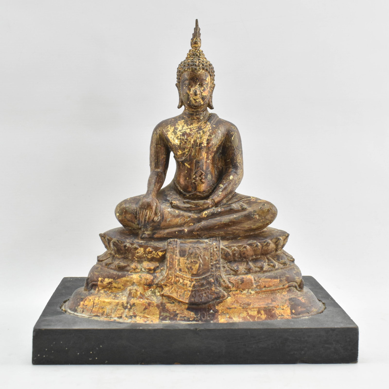 Vintage Buddha Sculpture on Wood Base: Metal sculpture with textured and gilt finishes on wood base. 10"H x 9"W x 5.75"D.