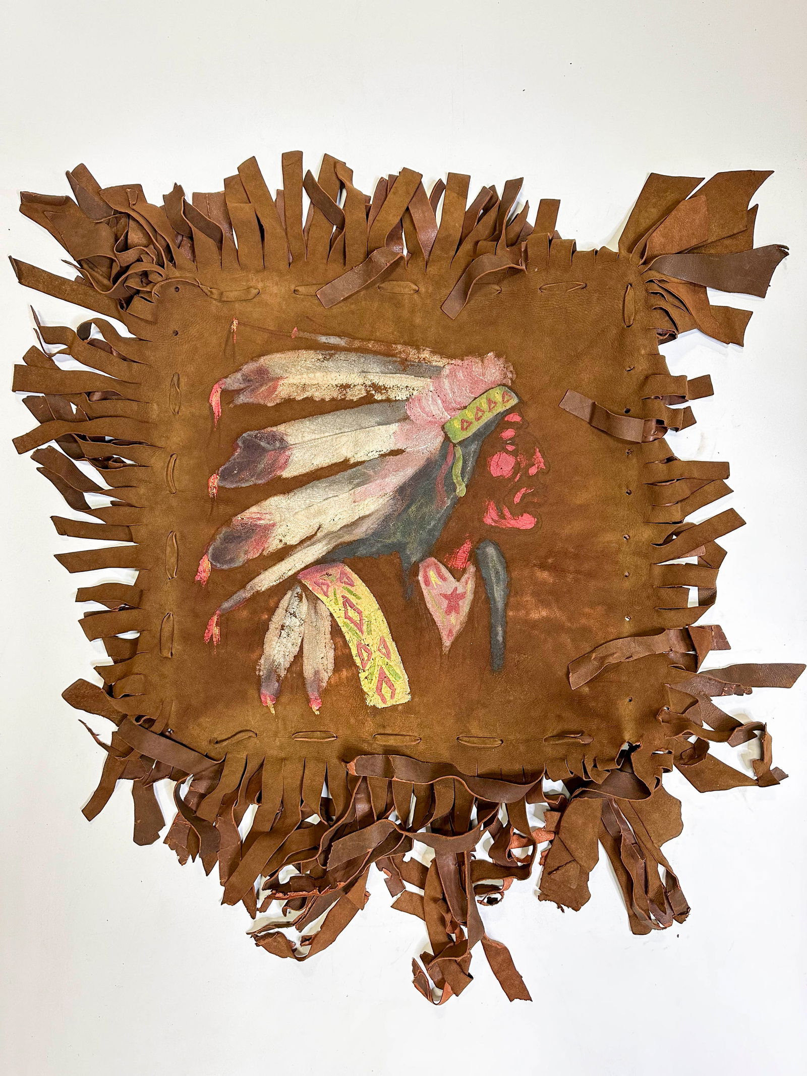 Leather Pillowcase with Indigenous Portrait: Leather fringe pillow case with a portrait of an First Nation person.