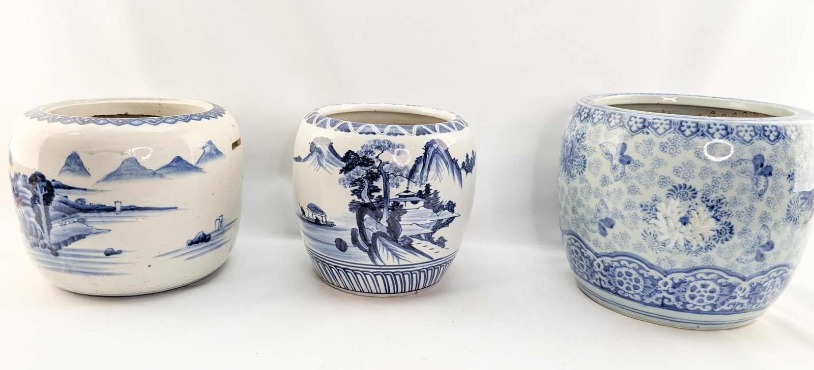 3 Blue & White Planters: 3 blue and white planters with landscape and floral decorations. Larest 10.25"H x 12"Dia.