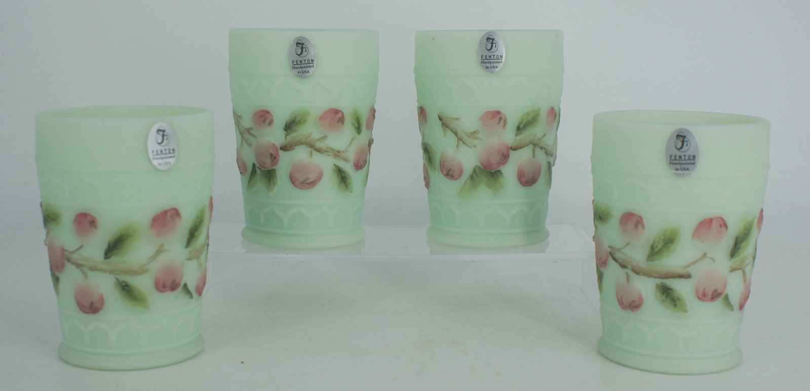 4 Fenton Glass Hand Painted Cherry Blossom Tumblers: Lot of 4 matching Fenton Glass hand painted tumblers with cherry blossom decoration throughout, each signed on the underside. Each: 4"H x 2 3/4"Dia