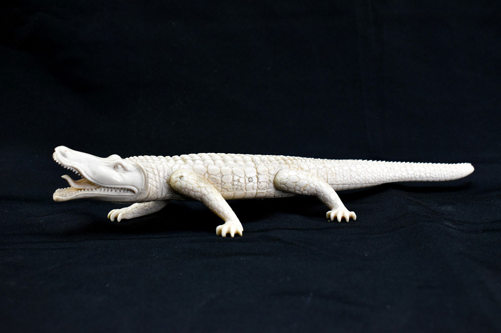 Carved Bone Crocodile: The crocodile is carved from bone, and made of separate smaller attached pieces.11.5" x 3" x 1.5"