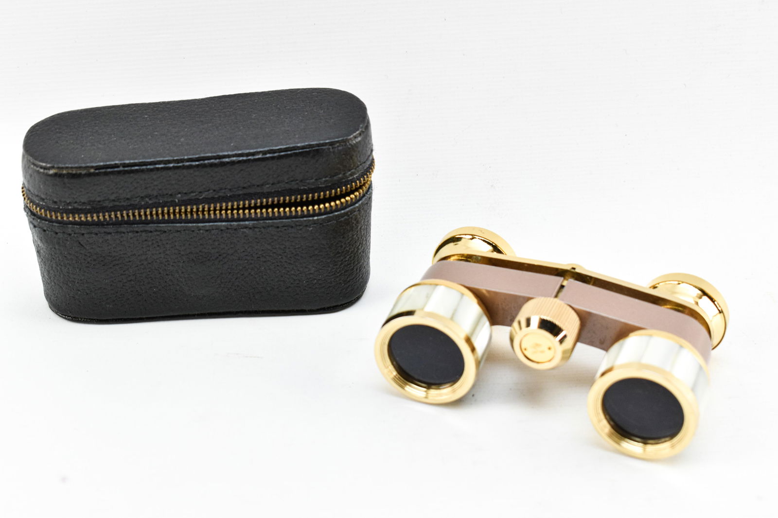 Vintage Bushnell Mother of Pearl Opera Glasses: Vintage pair of opera glasses made by Bushnell in Japan. Inlaid mother of pearl and gold finish. Includes case.1.25"H x 3.25"W x 2.25"L.