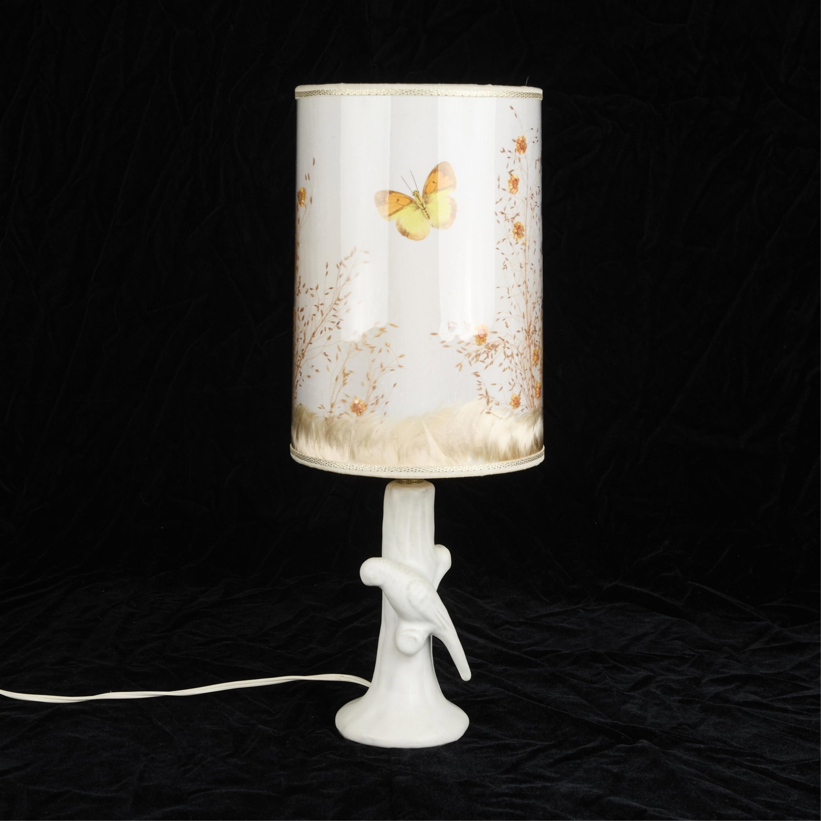 Van Briggle Pottery Parakeet Lamp: Van Briggle Pottery lamp in the form of a parakeet perching on a branch. Includes original butterfly shade. 18"H x 7.5"Dia.