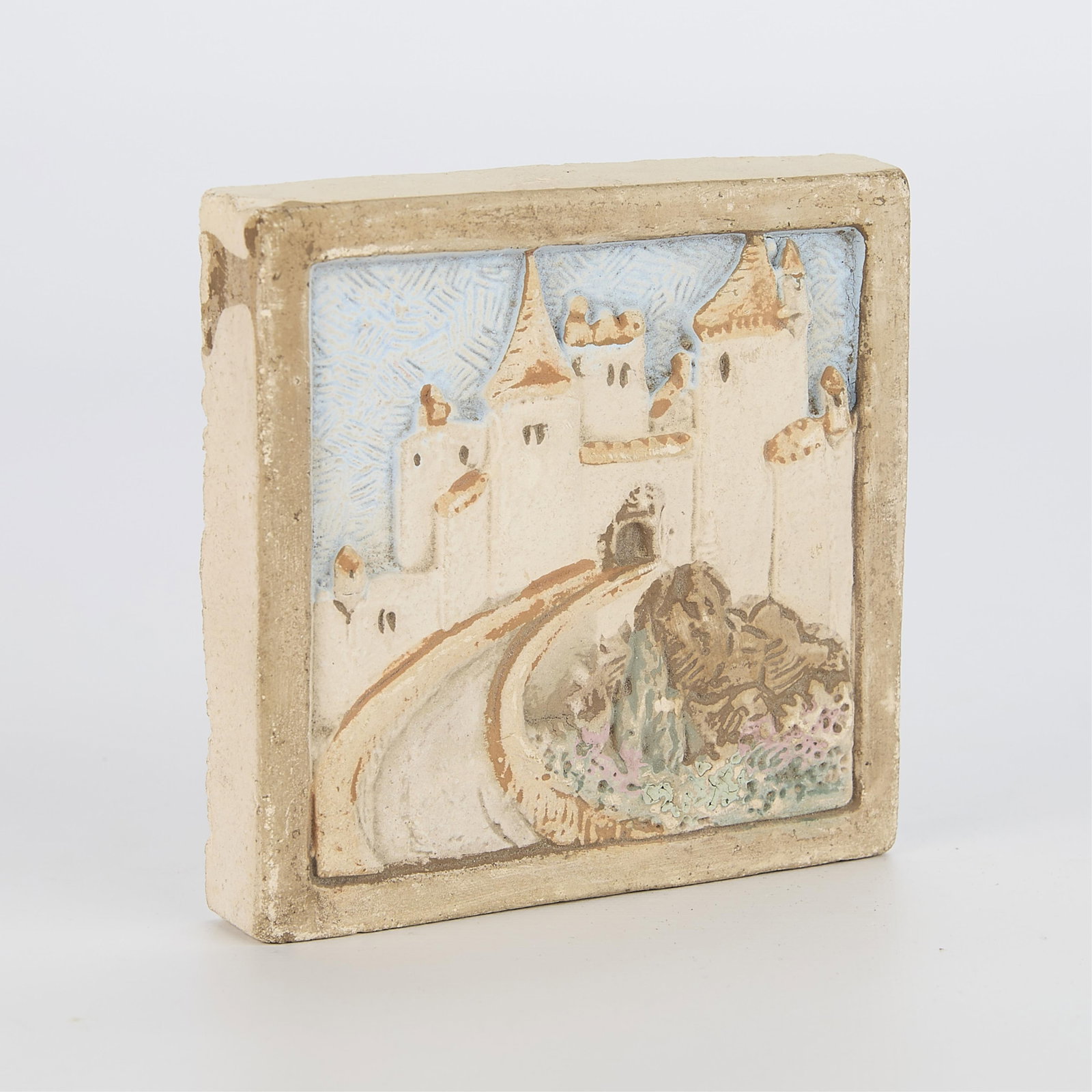 Small Vintage Claycraft Pottery Castle Tile: Claycraft Potteries, Los Angeles, California. Vintage tile with castle in relief against a blue, textured sky. Muted matte glazes, including blue, green, and beige, ca. 1921-1939.4"W x 4"L x