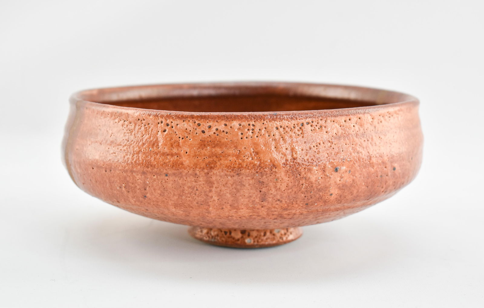 Warren MacKenzie Bowl, Unmarked: Bowl made by Warren MacKenzie with small foot and unglazed stripe down the center. Glaze and clay body are consistent with MacKenzie's work.3.25"H x 8"Dia.