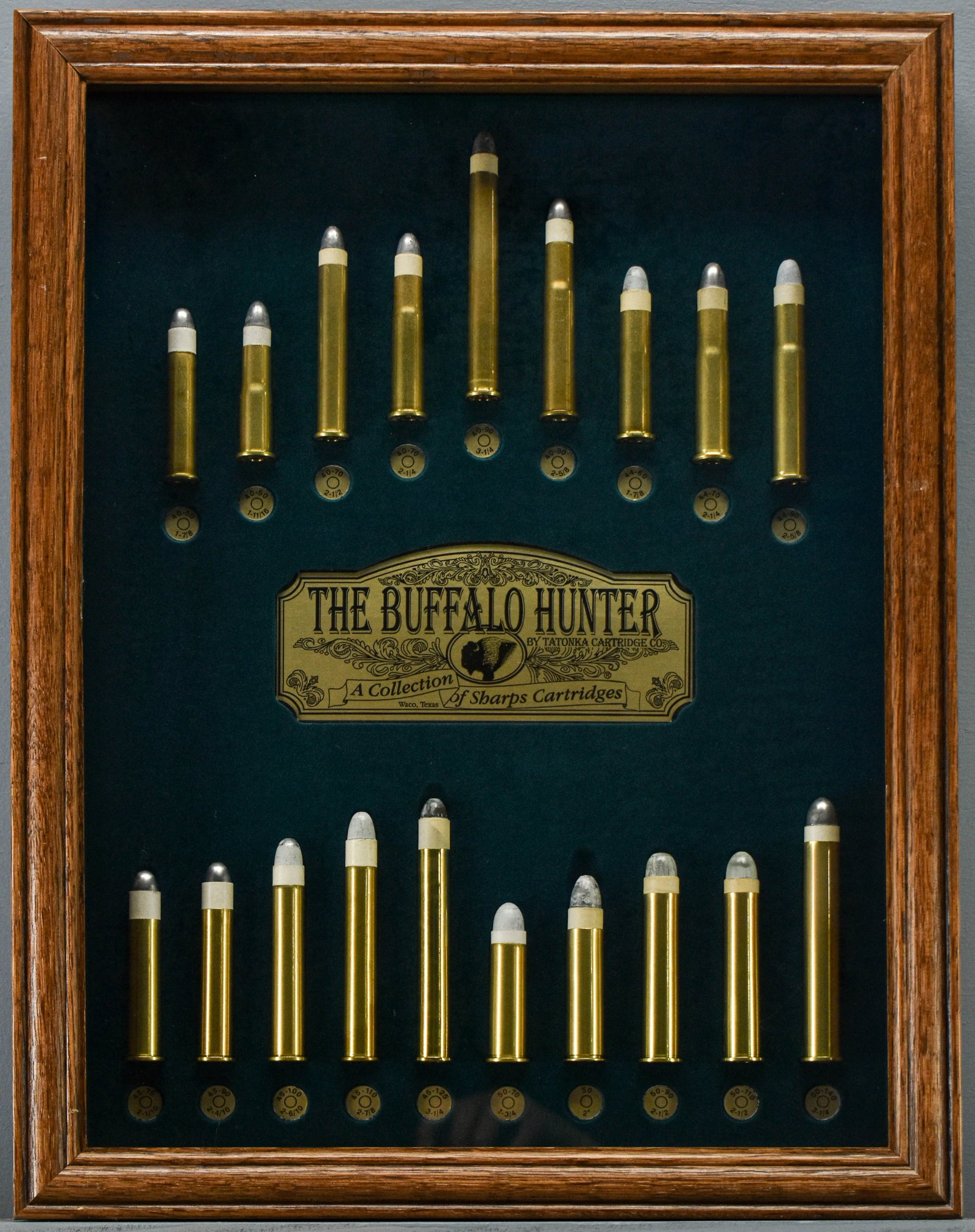 The Buffalo Hunter Tatonka Cartridge Co. Sharps Shadowbox Display: Ammunition is NOT live. The Buffalo Hunter by Tatonka Cartridge Co. collection of Sharps cartridges. This display includes 40 cal., 44 cal., 45 cal. & 50 cal cartridges displayed on a green velvet bac