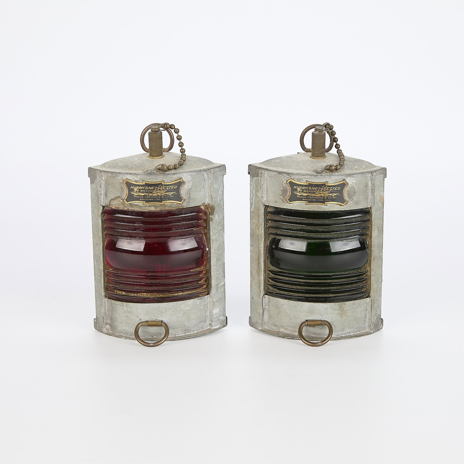 Pair of Antique Wilcox Crittenden Co. Port and Starboard Ship Lights: One green glass lamp and one red glass lamp made by Wilcox, Crittenden & Co, Inc of Middletown, Connecticut, U.S.A. Small metal plates on each lamp read "Hurricane Tested Marine Lights" and 