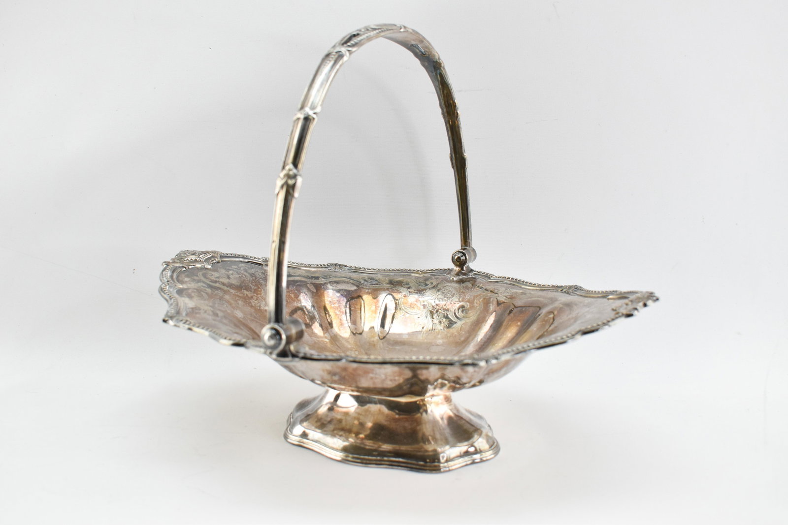 Sheffield Silverplate Bridal Basket, James Dixon & Sons: Handled bride's basket made by James Dixon & Sons, Sheffield, England. Etched details throughout and deisgns in relief along edges and handle. Monogrammed on handle. 10.5"H (with handle upright) 