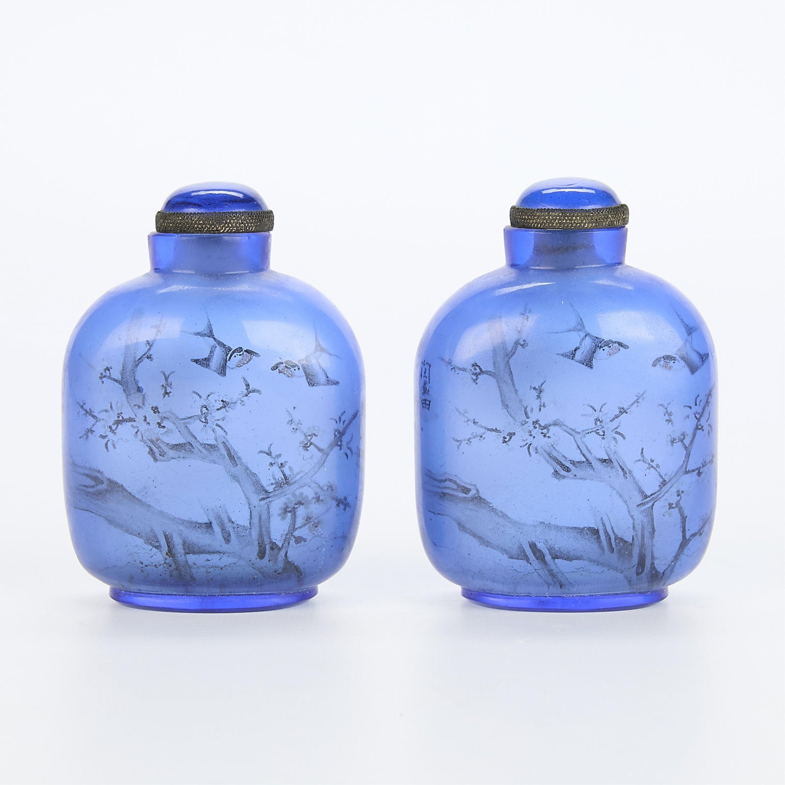 Pair Chinese Cobalt Blue Glass Inside-Painted Snuff Bottles: Pair of large Chinese inside-painted cobalt blue glass snuff bottles, each depicting a landscape. EACH: 3 3/4"H x 2 3/4"W x 1 3/4"D.