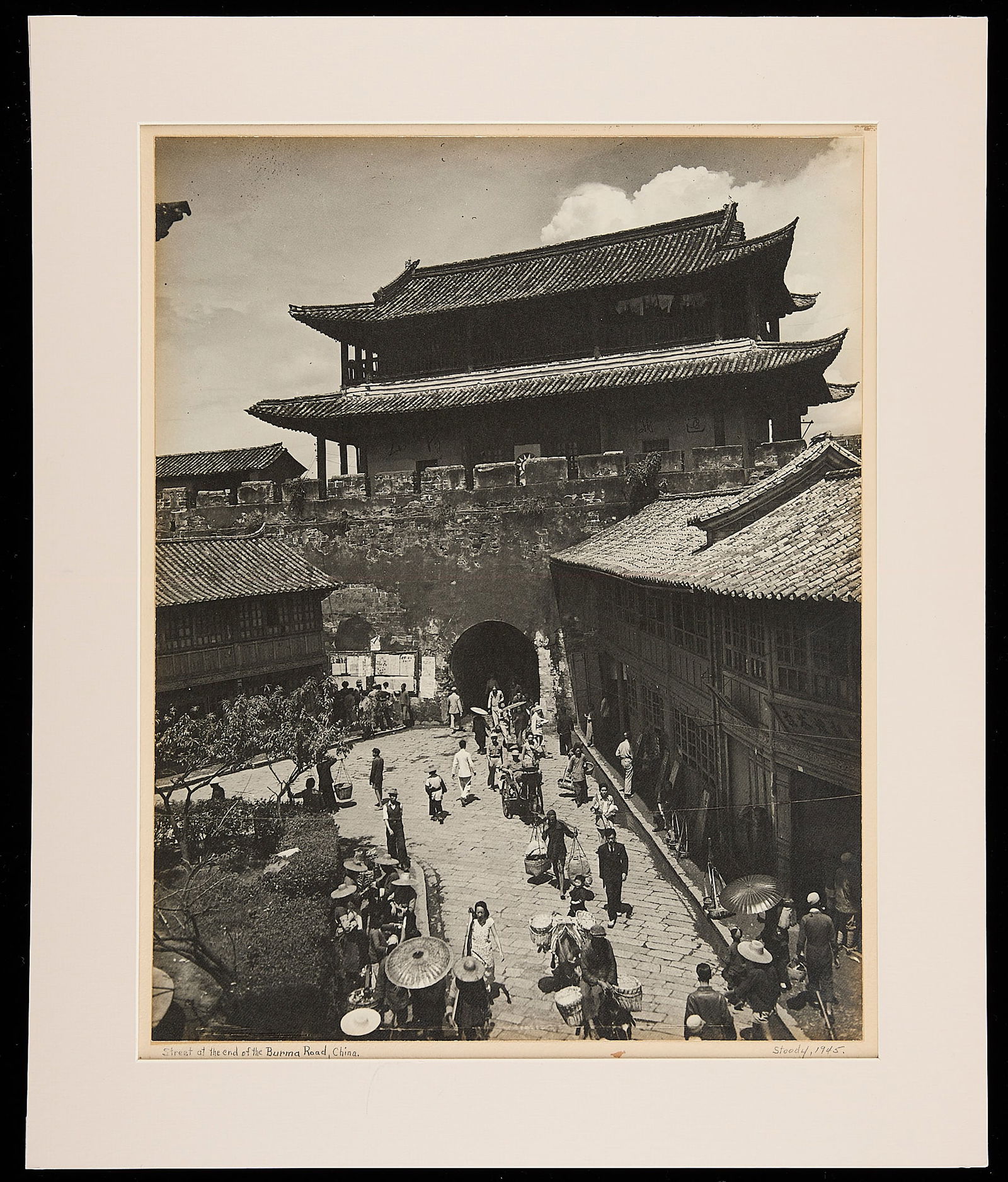 "Street at the End of the Burma Road" Photograph by Clarence Ferrell Stoody, 1944: Original WWII era documentary photograph by Clarence Ferrell Stoody (1906-1986). Pencil signed ?Stoody? with title and date. Images were shot with a Graflex Crown Graphic. Rare photo.Photo shows road