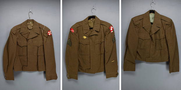 Three U.S. Army WWII Era Field Jackets: Three wool U.S. Army WWII era field jackets. Two have unit insignia and one is blank. Comes in a denim garment bag.