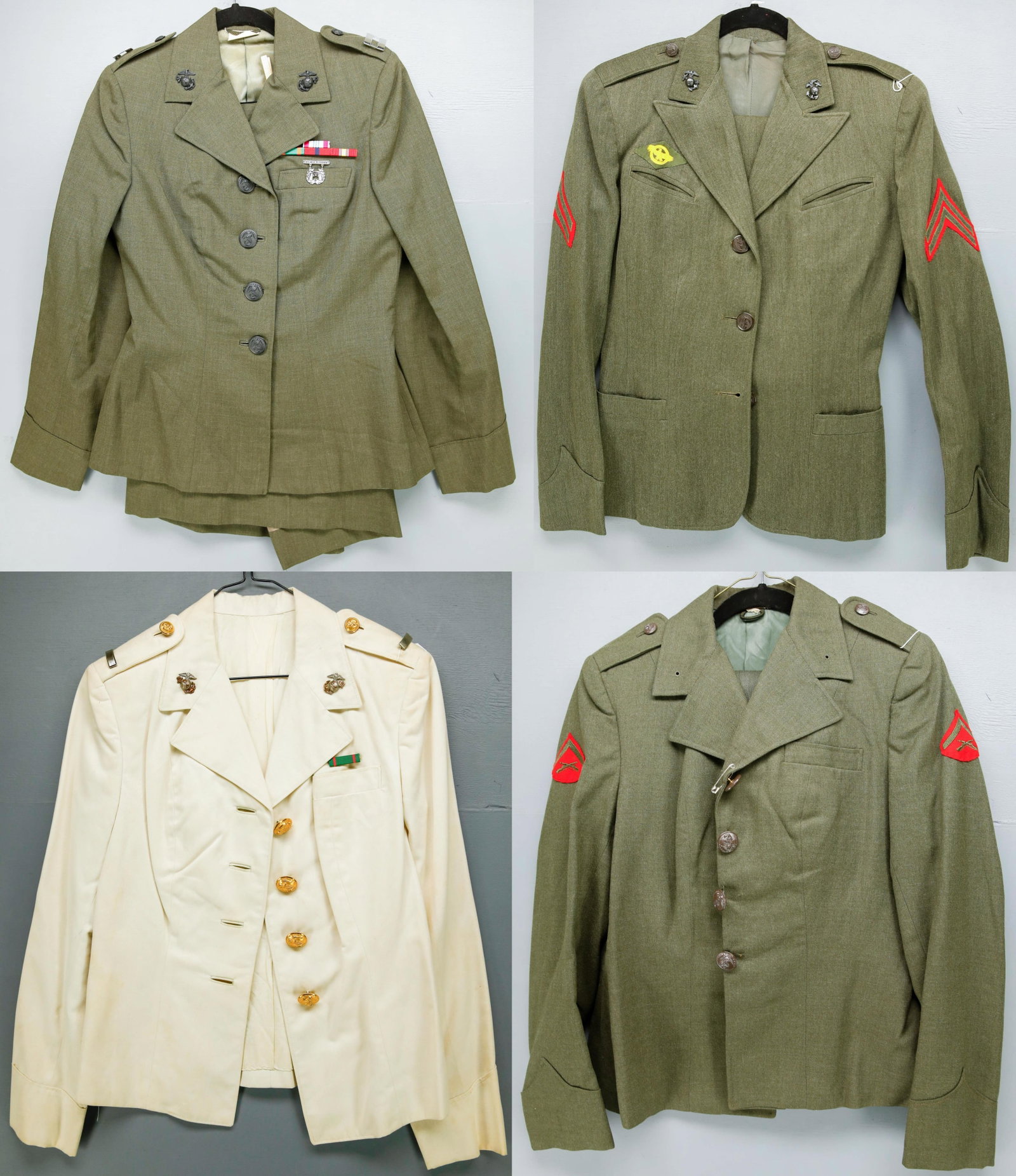 U.S. Marines Women's Uniforms: U.S. Marines Women's uniforms including 3 dress green jackets with 3 matching skirts and trousers, one white dress jacket. Captain, Lieutenant insignia with service medals and other insignia. Comes in