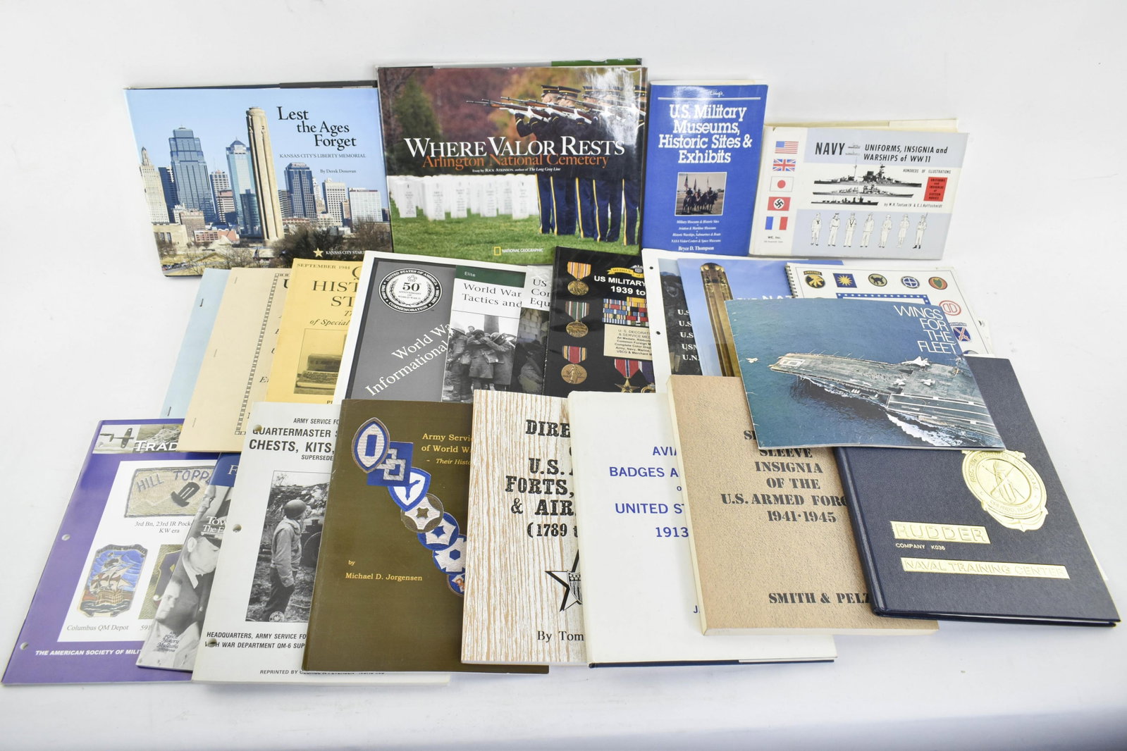 Group Military Booklets and Books: Assorted collection of books and booklets covering a range of military topics.