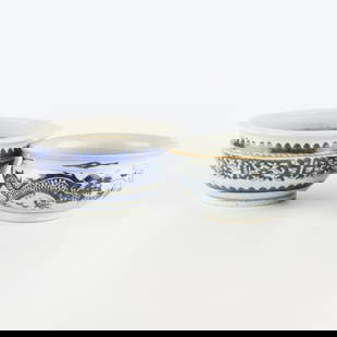 2 Chinese B&W Ceramic Bowls: Group of two Chinese ceramic or porcelain bowls. One decorated with scrollwork in blue and white. The other decorated with a dragons chasing a flaming pearl in dark blue, almost black, and white.Small