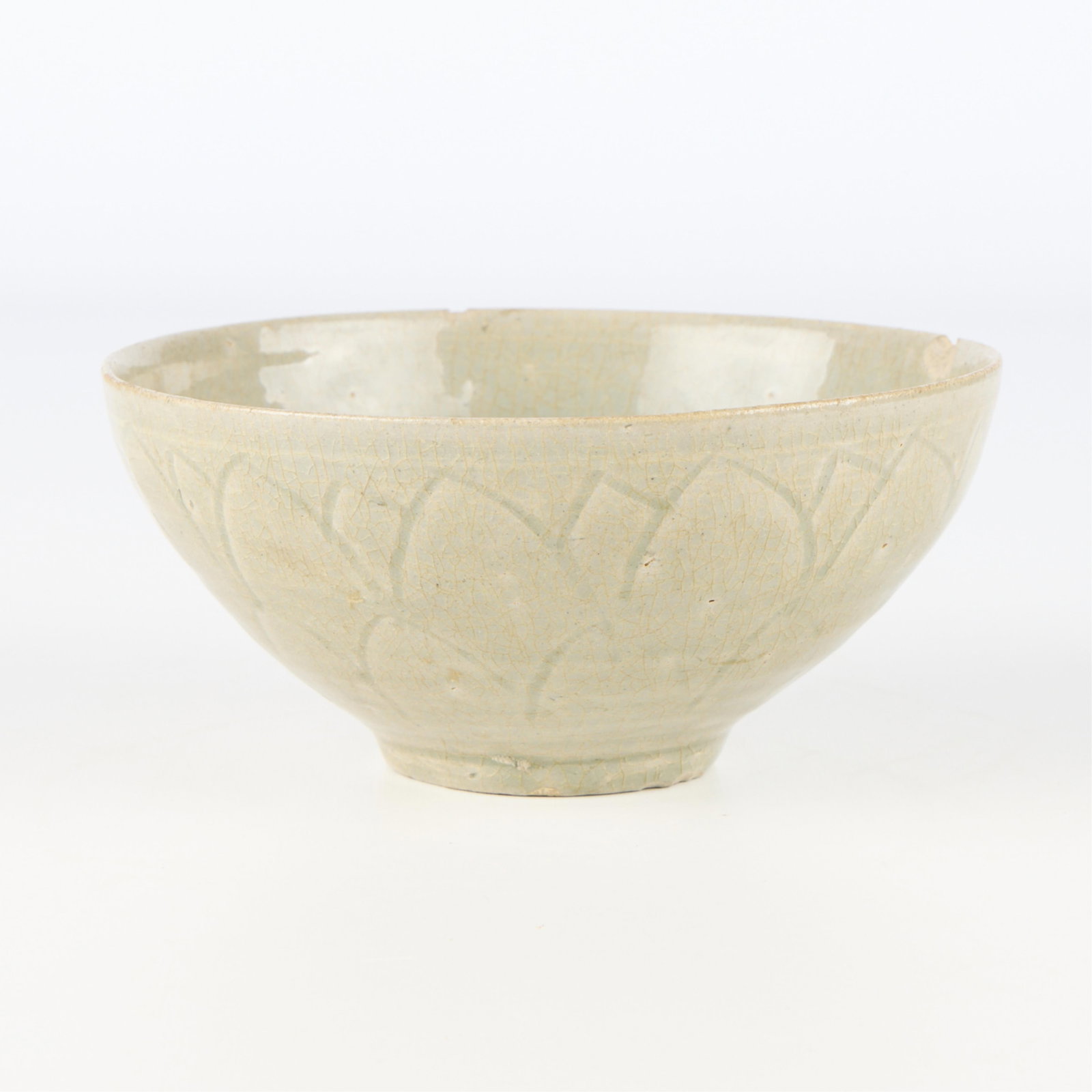Chinese Song Incised Ceramic Bowl: Chinese Song dyansty ceramic bowl with incised lotus petal decoration along the exterior and a pale celadon glaze.Height: 3 in x diameter: 6 1/2 in.