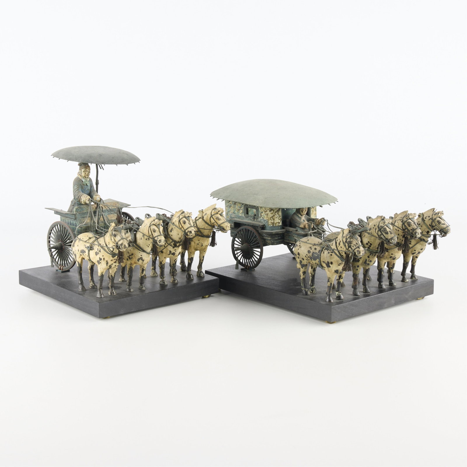 2 Painted Bronze Chinese Qin Chariot Replica: Set of two painted bronze Qin bronze chariot replicas. Each includes four speckled horses, a open chariot or closed carriage, and driver shielded by an umbrella roof. The Qin bronze chariots refer to 