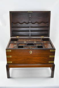 Rosewood Writing Box with Brass Fittings: Rosewood writing box with stand made in British Colonial India from the 19th century. Many compartments - even a false bottom that reveals secret storage.Note: Wear to key makes locking and unlocking