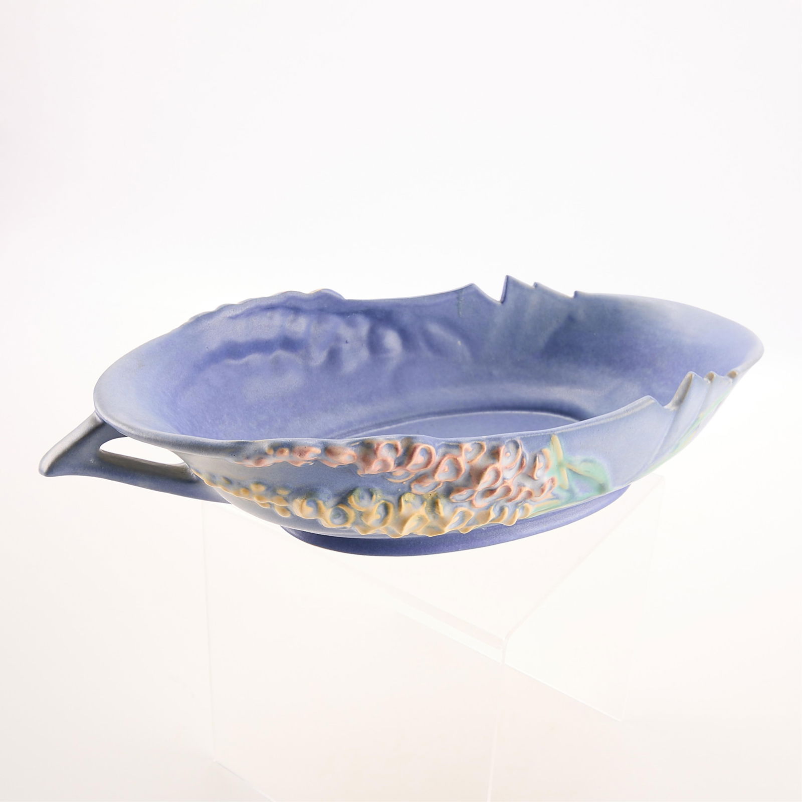 20th c. Roseville Foxglove Blue Centerpiece Bowl: Roseville Pottery Company, Ohio. Blue, pink, and yellow ceramic centerpiece bowl in design "Foxglove." Design introduced 1942. Signed and numbered 423-12 along the underside.3 1/4"H x 15 3/4"W x 7 3/4