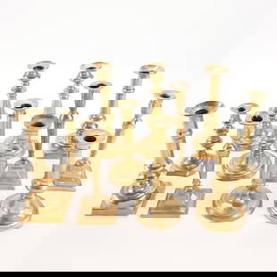 11 Brass Candlesticks: Group of 11 brass candlesticks. Including three matching pairs and five singular sticks.Height ranges from 6 1/4 in to 8 3/4 in; width ranges from 3 1/4 in to 4 1/4 in; depth ranges from 3 1/4 in to 4