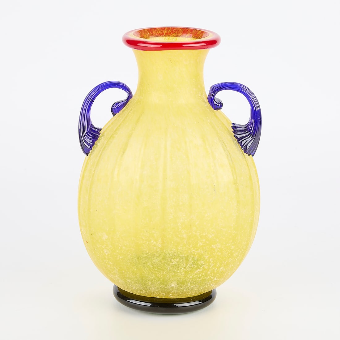 Colorful Murano Style Scavo Vase: Murano style vase with scavo finish. Yellow body with red rim, applied blue handles and a green base. Appears unmarked. 9.75"H x 6.5"W x 4.5"L.
